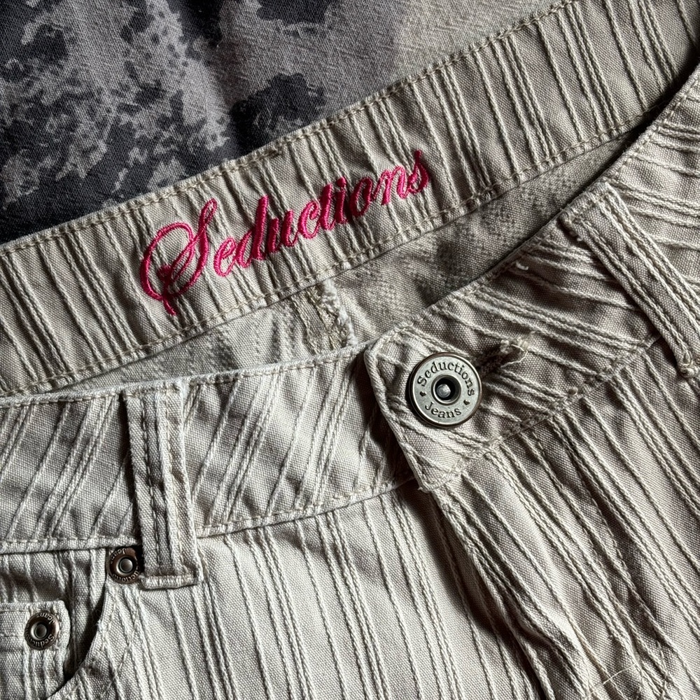 Cream and tan striped low-rise bootcut jeans